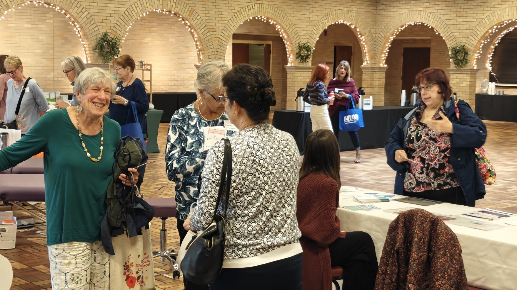 Community members gathered together in warm conversation at an event