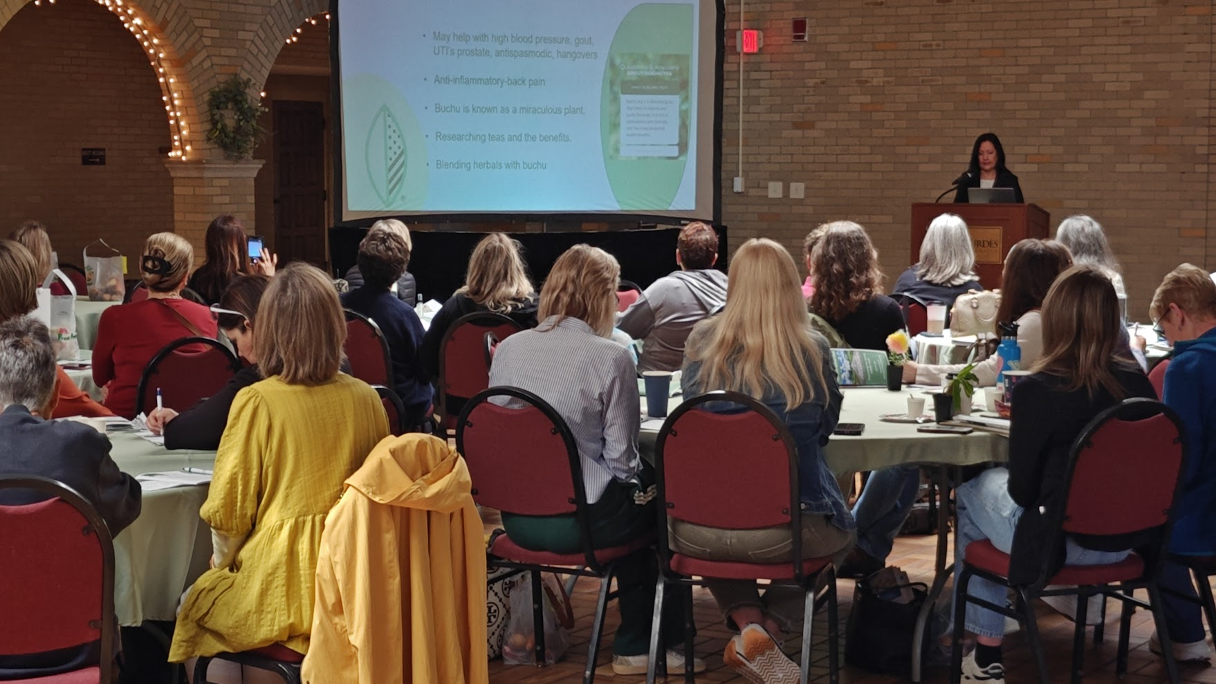 A gathered audience listening together at a learning event